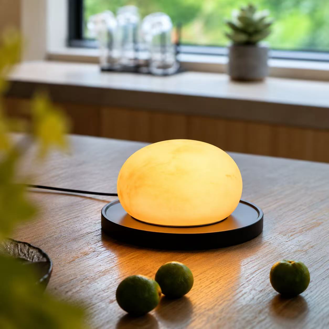 Marble-effect lamp placed on a tabletop surface with a power cord